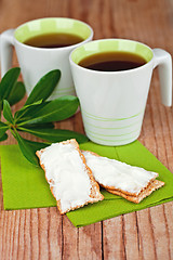 Image showing two cups of tea and crackers with cream cheese 