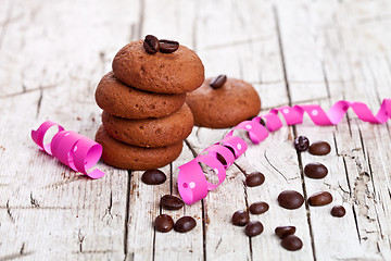 Image showing fresh chocolate cookies, coffee beans and pink ribbons