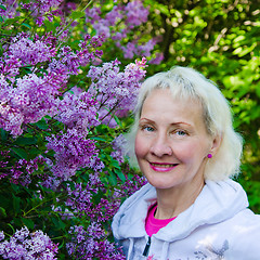 Image showing Portrait of a woman from a Bush blooming lilac 