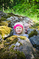 Image showing Young children, the boy with the girl hid among the rocks