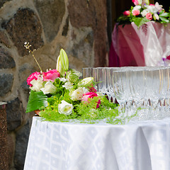 Image showing Bouquet of flowers and wine glasses for a wedding table 