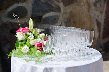 Image showing Bouquet of flowers and wine glasses for a wedding table 