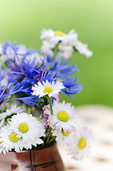 Image showing Bouquet of daisies on the table in the garden. Summer background