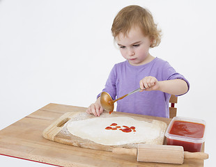 Image showing girl making pizza
