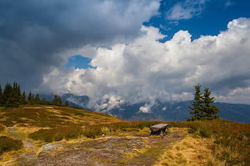 Image showing Lonely empty wood bench on the mountain