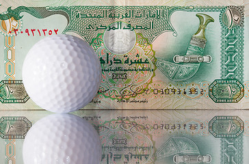 Image showing Dirhams and golf ball