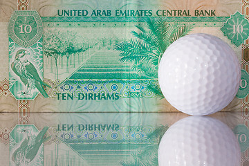 Image showing Dirhams and golf ball