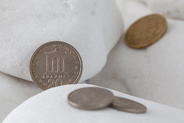 Image showing Greek drachma coins on a white stones