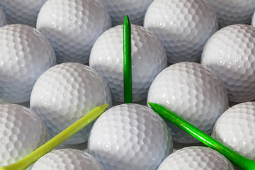 Image showing Golf balls and wooden tees in open box