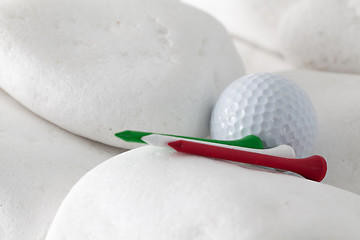 Image showing Golf ball and tees between white stones