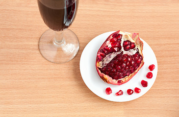 Image showing Goblet of wine and a pomegranate on the table