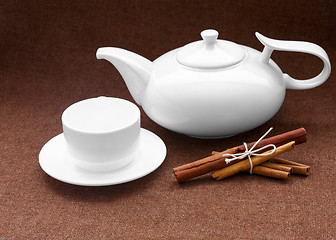 Image showing teapot, cup and cinnamon on sacking