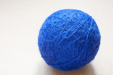 Image showing blue wool yarn skein on cardboard background