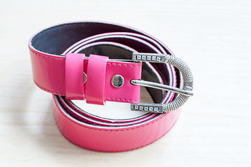 Image showing pink women style belt on wooden background