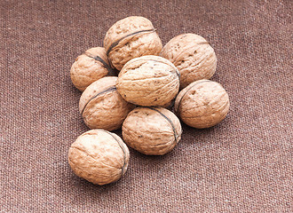 Image showing walnuts close up on the burlap background