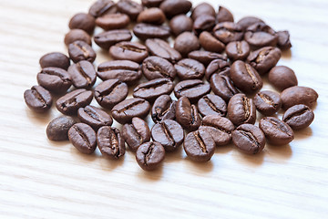 Image showing coffee beans on white wooden background