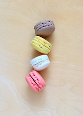 Image showing Colorful macaroons on wooden background