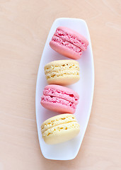 Image showing pink and yellow macaron on a plate