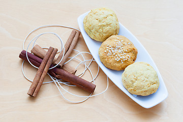 Image showing biscuits on a plate and cinnamon sticks