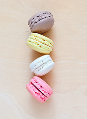 Image showing Colorful macaroons on wooden background