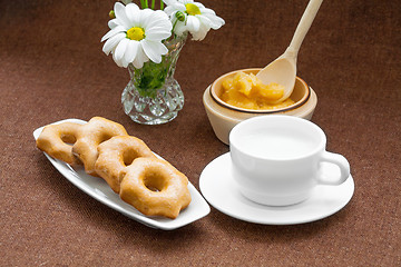 Image showing honey cookies, cup and a vase of daisies