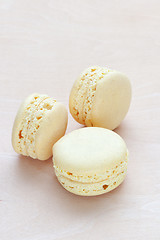 Image showing yellow macaron on wooden background