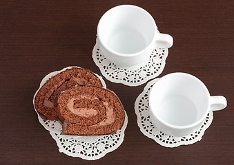 Image showing chocolate roll on napkins and cup