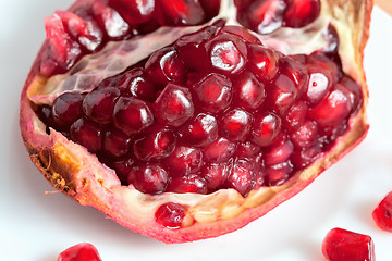 Image showing The cut pomegranate and grains on a plate