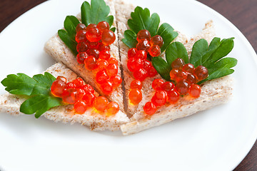 Image showing Tartlets with caviar and parsley on a plate