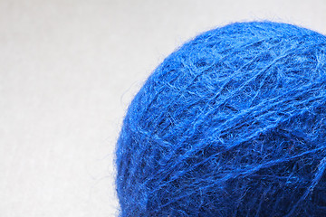 Image showing blue wool yarn skein on cardboard background