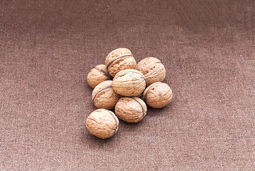 Image showing walnuts close up on the burlap background