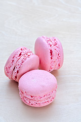 Image showing pink macaron on wooden background