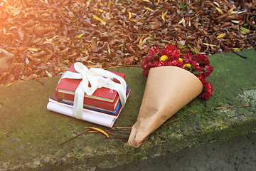 Image showing bouquet of chrysanthemums and a stack of books