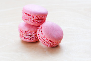 Image showing pink macaron on wooden background