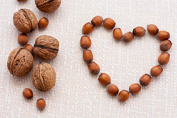 Image showing walnuts, hazelnuts on a wooden background