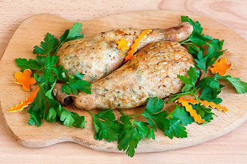 Image showing Fried chicken legs with parsley on the board