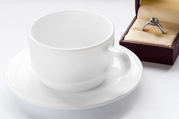 Image showing silver ring with a diamond and a cup and saucer