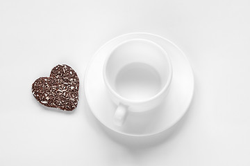 Image showing cup and saucer and a chocolate coconut cookies