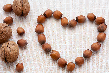 Image showing walnuts, hazelnuts on a wooden background