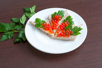 Image showing Tartlets with caviar and parsley on a plate