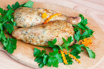 Image showing Fried chicken legs with parsley on the board