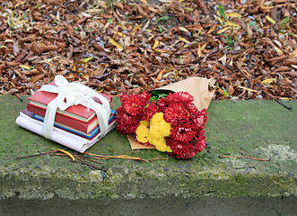 Image showing bouquet of chrysanthemums and a stack of books