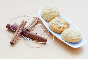 Image showing biscuits on a plate and cinnamon sticks