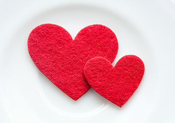 Image showing Red hearts on a plate close-up. Valentine's Day