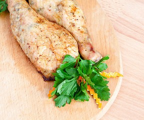 Image showing Fried chicken legs with parsley on the board