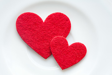 Image showing Red hearts on a plate close-up. Valentine's Day