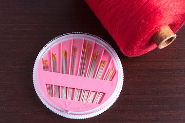 Image showing pack of needles and a skein of thread