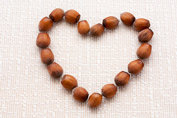 Image showing walnuts, hazelnuts on a wooden background