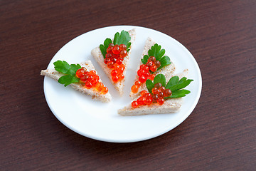 Image showing Tartlets with caviar and parsley on a plate