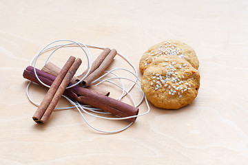 Image showing biscuits, cinnamon sticks and a cord